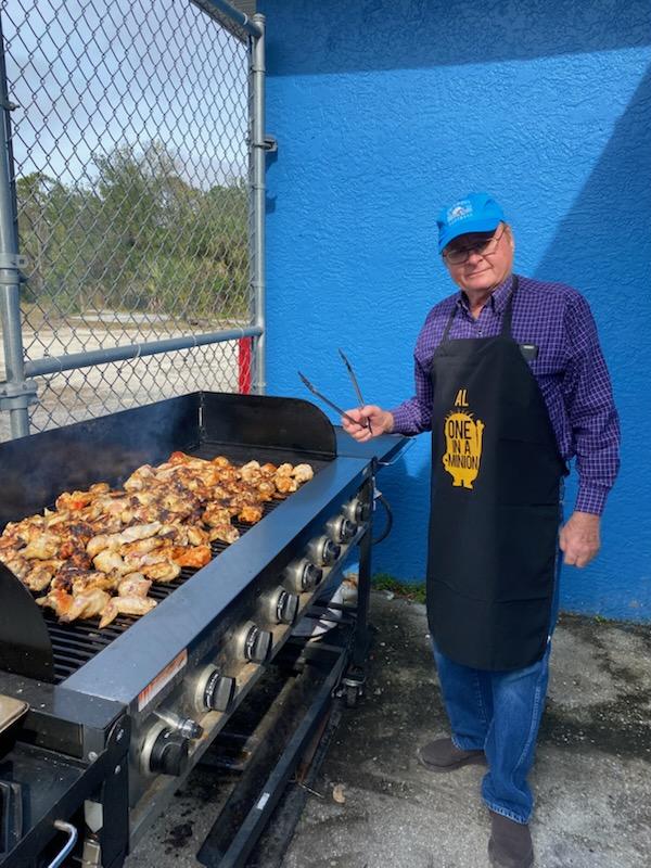 Volunteer grilling at community cookout