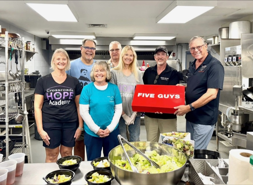 Crossroads Hope Academy volunteers with Five Guys meal donation